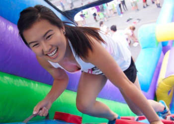 Girl climbing inflatable party rental from Jumptastic in Athens, GA