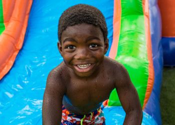 Boy playing on water slide