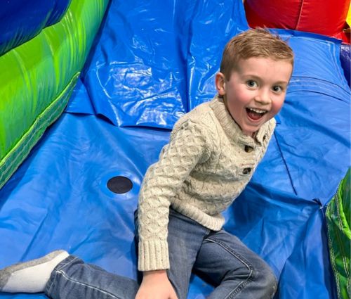 Boy playing on colorful bounce house