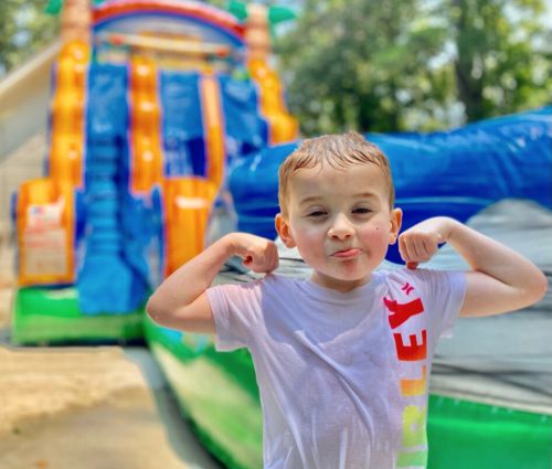 Boy posing in front of water slide rental in Covington, GA