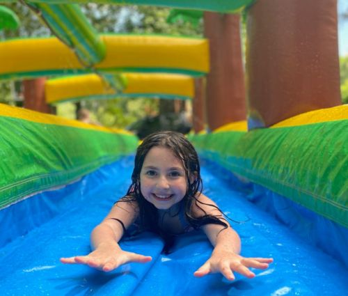 Girl having fun on Slip and Slide